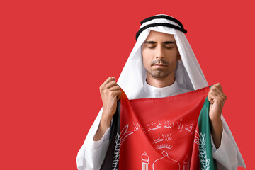 Muslim man with flag of Afghanistan on color background