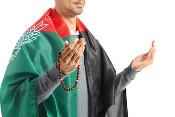 Praying Muslim man with flag of Afghanistan on white background