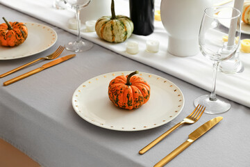 Beautiful autumn table setting with pumpkin at restaurant