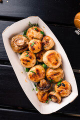 grilled grilled mushrooms to take away in a cardboard box