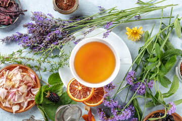 Tea. Herbs, flowers and fruit around a cup of tea, an overhead flat lay shot. Healthy organic hot...