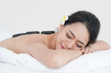 Obraz na płótnie Canvas young woman massage in stone spa salon