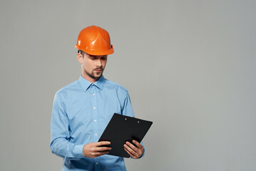 man in orange helmet blueprints builder isolated background