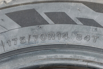 Detail view of tire with tire width, height and wheel diameter designation.