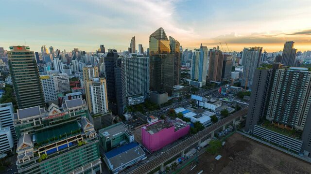 Aerial view of ฺasoke intersection or junction with cars traffic skyscraper buildings. Bangkok City in downtown at night, Thailand