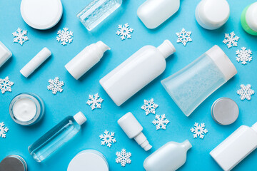 Makeup products and Christmas decorations on color background. Top view New year Beauty concept