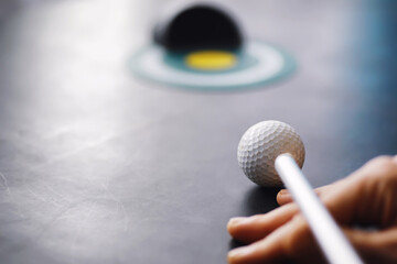 Sport and healthy lifestyle. Mini golf. White golf ball and set for minigolf on the table. Sports background with golf concept.