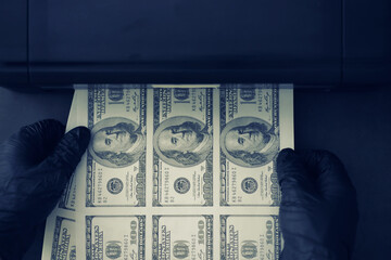 The concept of the global economic crisis. Illegal production of US dollars. Print money underground. Printing hundred dollar bills by a criminal. - obrazy, fototapety, plakaty