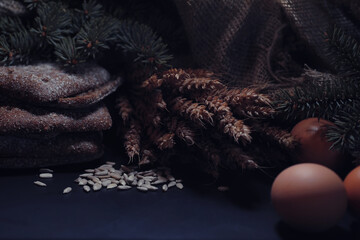 Fresh loaves of bread with wheat and gluten on a black table. Bakery and grocery concept. Fresh, healthy sorts of rye and white loaves food closeup. Fresh homemade bread with cereals.