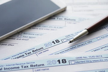 Annual tax reporting. Tax form on the table. Financial statements for signature.