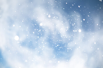 Fototapeta premium blue snowfall bokeh background, abstract snowflake background on blurred abstract blue