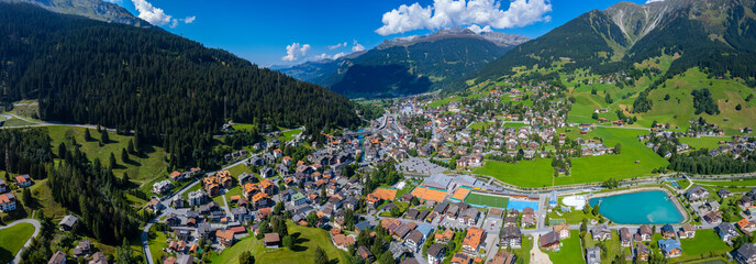 Aerial view around the city Klosters-Serneus in Switzerland on a sunny day in summer.