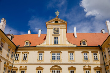 Fototapeta premium Valtice castle, Southern Moravia, Czech Republic, 04 July 2021: Baroque old historic residences, popular travel destination at sunny summer day, UNESCO world heritage, Sculptures in ornamental garden
