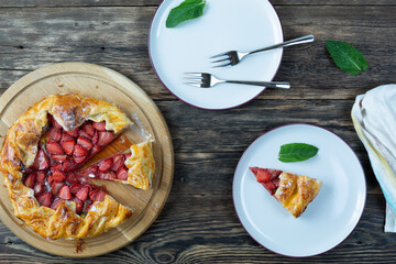 tart with strawberries on a wooden table. Copy space, top view.