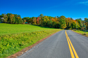 Road across countryside in foliage season.