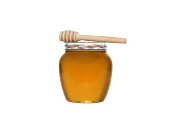 Glass jar with delicious fresh honey. There is a wooden ladle nearby. White isolated background.