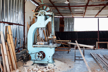 Industrial band saw machine in a carpentry or lumber workshop.