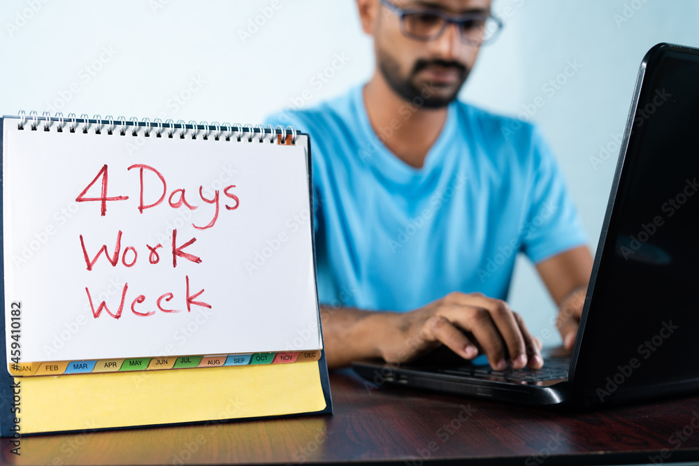 Wall mural focus on calender, concept of four or 4 days work week showing by young man working in background an