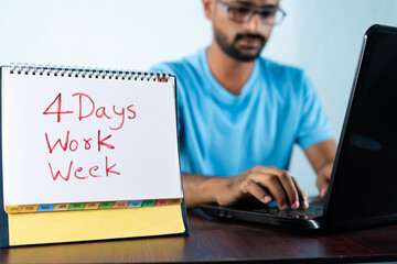 focus on calender, Concept of four or 4 days work week showing by young man working in background and shows calendar. - obrazy, fototapety, plakaty