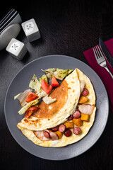 Fried eggs with sausages in olive oil. Hearty breakfast