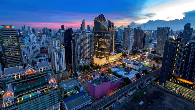 Aerial view of Siam Bangkok intersection or junction with cars traffic skyscraper buildings. Bangkok City in downtown at night, Thailand. 