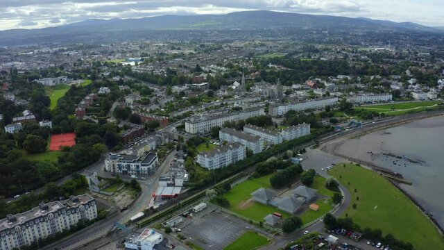 D&uacute;n Laoghaire Harbour, Dublin, Ireland, September 2021. Drone tracks a Dart train east along the coast from Monkstown.