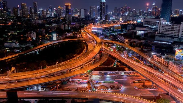 Aerial view of Siam Bangkok intersection or junction with cars traffic skyscraper buildings. Bangkok City in downtown at night, Thailand. 