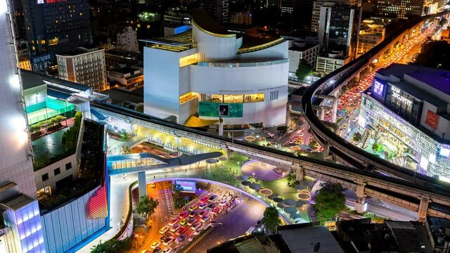 Aerial view of Siam Bangkok intersection or junction with cars traffic skyscraper buildings. Bangkok City in downtown at night, Thailand. 