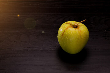 Green apple on black trees boards