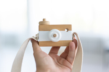 Toy wooden camera for children or decoration kid holding in hand