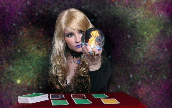 Psychic with blonde hair Crystal Ball and tarot cards