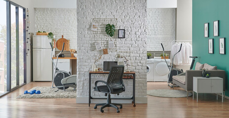 Decorative working room with brick wall, chair, laptop and home office style. Wooden desk with lamp style.