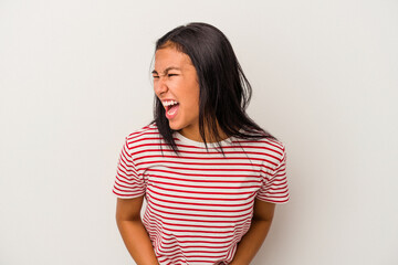 Young latin woman isolated on white background  shouting very angry, rage concept, frustrated.