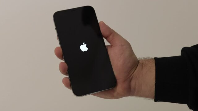 BRCKO, BOSNIA AND HERZEGOVINA - Dec 07, 2020: A male powering on iPhone 12 Pro Max