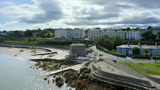 Martello Tower, Seapoint, Monkstown, Dublin, Ireland, September 2021. Drone slowly ascends while orbiting to reveal a view down the coast towards D&uacute;n Laoghaire harbor.