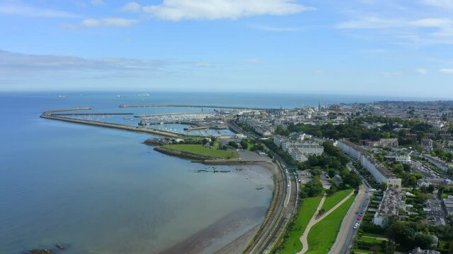 D&uacute;n Laoghaire Harbour as seen from Seapoint, Monkstown, Dublin, Ireland, September 2021. Drone gradually pushes east along the coast towards the harbour and Dublin bay.