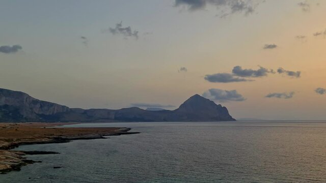 Left to right panning view of Baia Santa Margherita bay in Sicily at sunset near San Vito Lo Capo. Italy