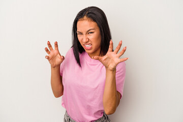 Young latin woman isolated on white background  upset screaming with tense hands.