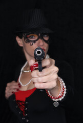 Fototapeta na wymiar Woman Wearing Lace Mask With Gun Shallow DOF focus on Gun Gangster Styler