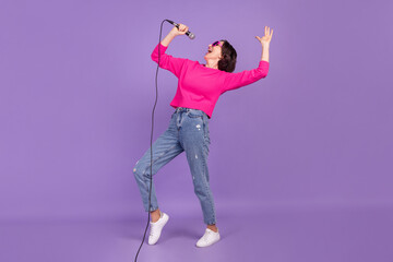 Full length body size view of attractive talented cheery woman singing having fun isolated over...