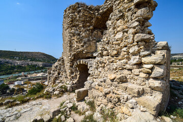 Naklejka premium A fragment of an old stone fortress standing on a mountain