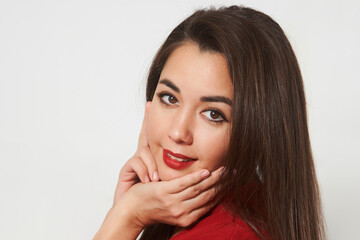 Portrait of a beautiful smiling young girl in red dress