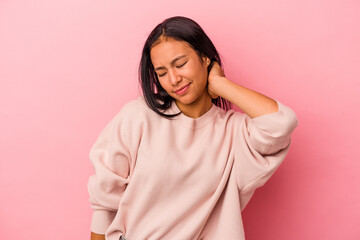 Fototapeta premium Young latin woman isolated on pink background having a neck pain due to stress, massaging and touching it with hand.