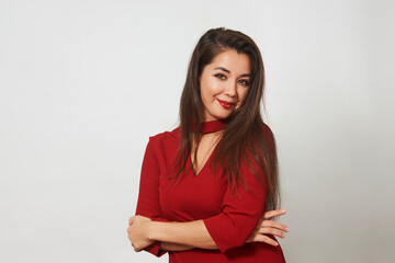 Beautiful woman posing in red dress on white background