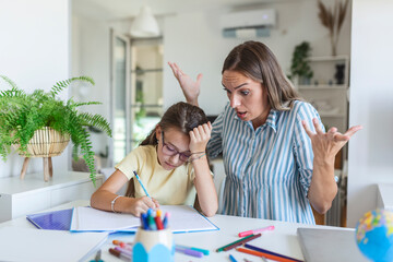 Do not ignore me when I am talking. Moms helping with homework. Mom is angry because her daughter dont want to do homework. Stressed mother and daughter frustrated over failure homework.