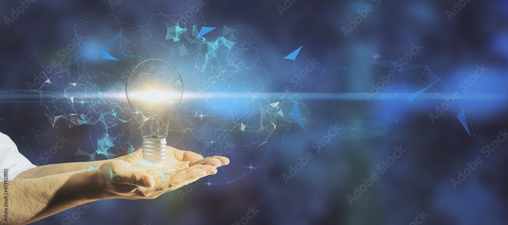 Poster close up of hand holding glowing polygonal lamp on blurry blue background with mock up place. idea a