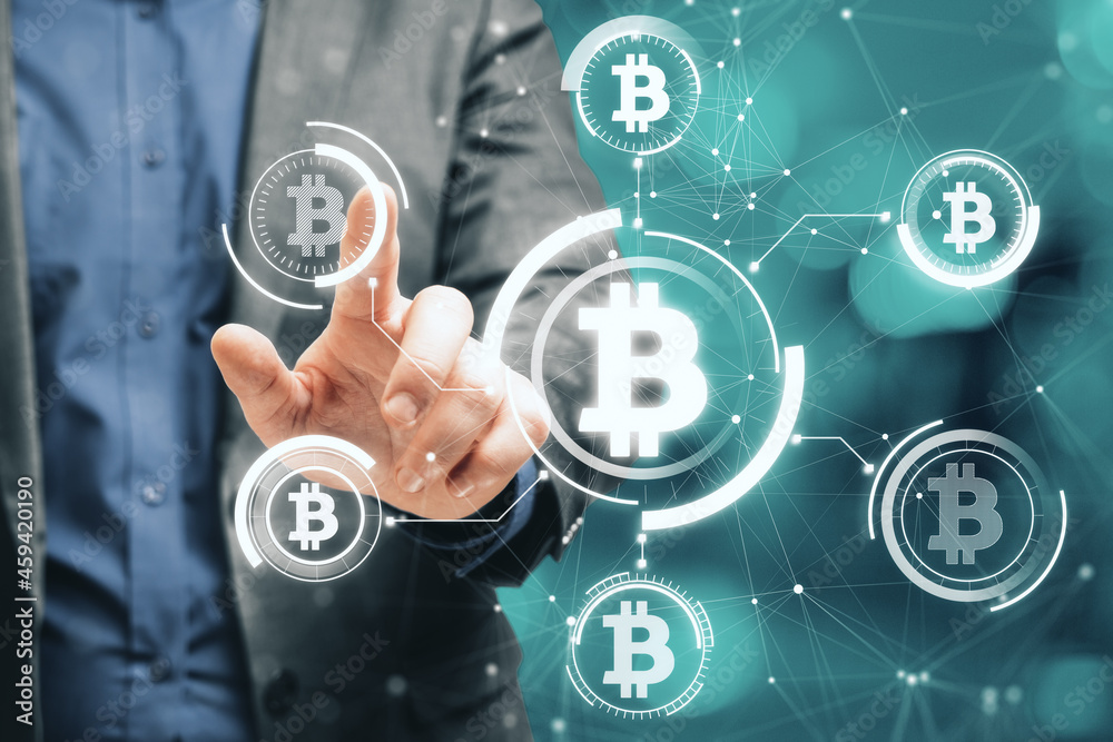 Poster Close up of businessman hand pointing at abstract glowing bitcoin hologram interface on blurry bokeh background. Cryptocurrency and blockchain concept. Double exposure.
