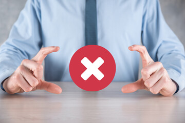 Hand holds icon,cancellation symbol,cancel icon.Cross mark flat red icon.round X mark.cancel button.Wrong.cross mark rejection.Declined.On dark background.Banner.Copy space.Place for text.