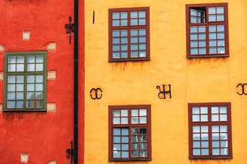 yellow house and red house with windows