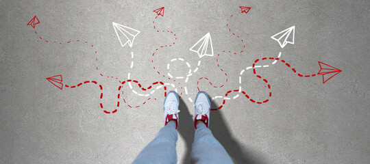Top view of female feet on concrete ground with different arrows. Way, solution, direction and...
